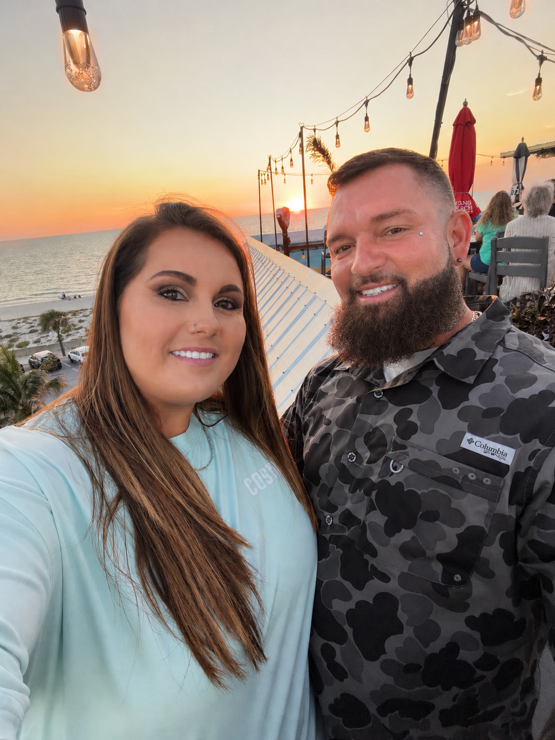 Lucas and Crystal smiling together at sunset