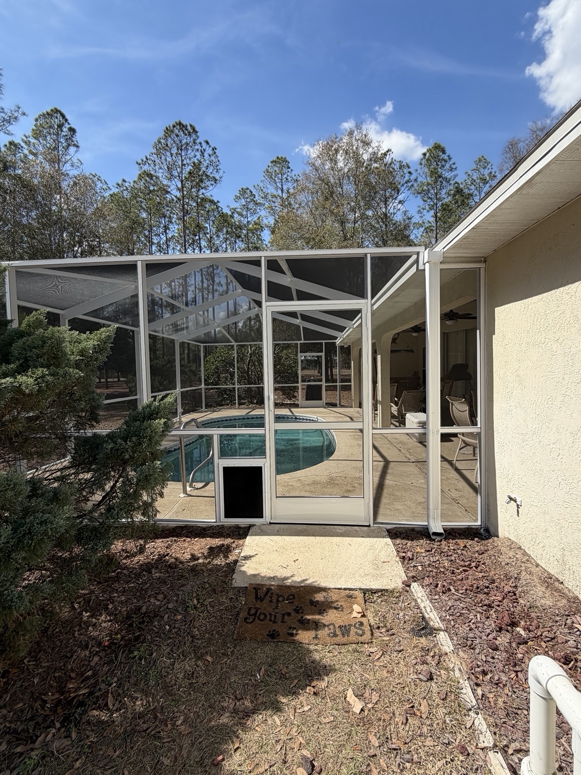 Pet door installed beside an enclosure door